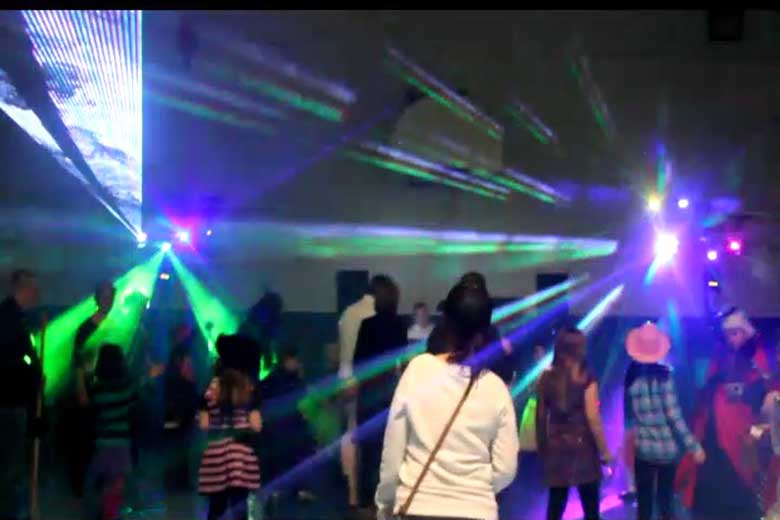 School Laser Light Show, Hamilton DJ, Family Dance, guests dancing with laser beams & special  effects beams  everywhere, blue, red, green, pink & white. Taken in Hamilton.